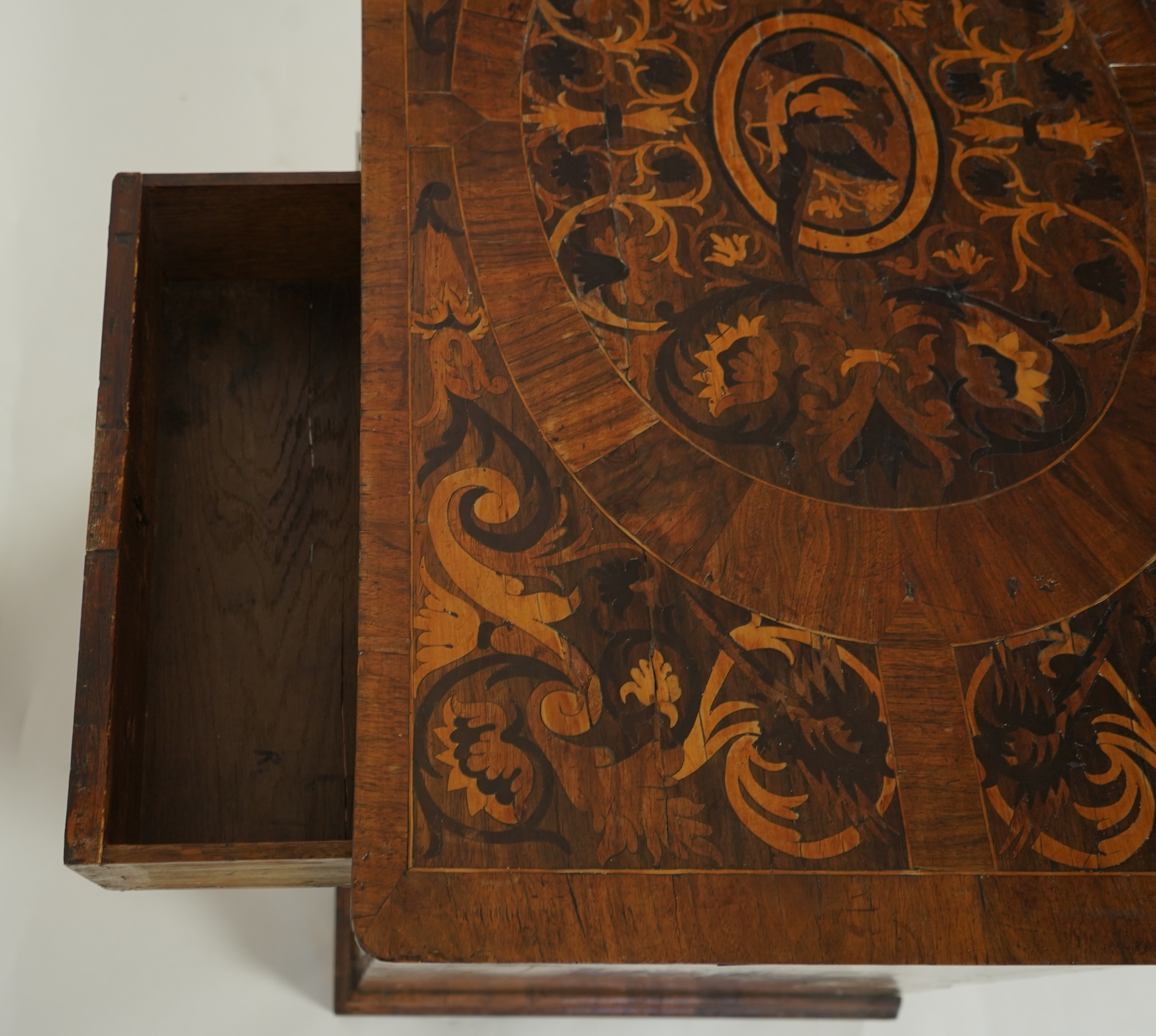 A William and Mary walnut and floral marquetry chest on later bracket feet